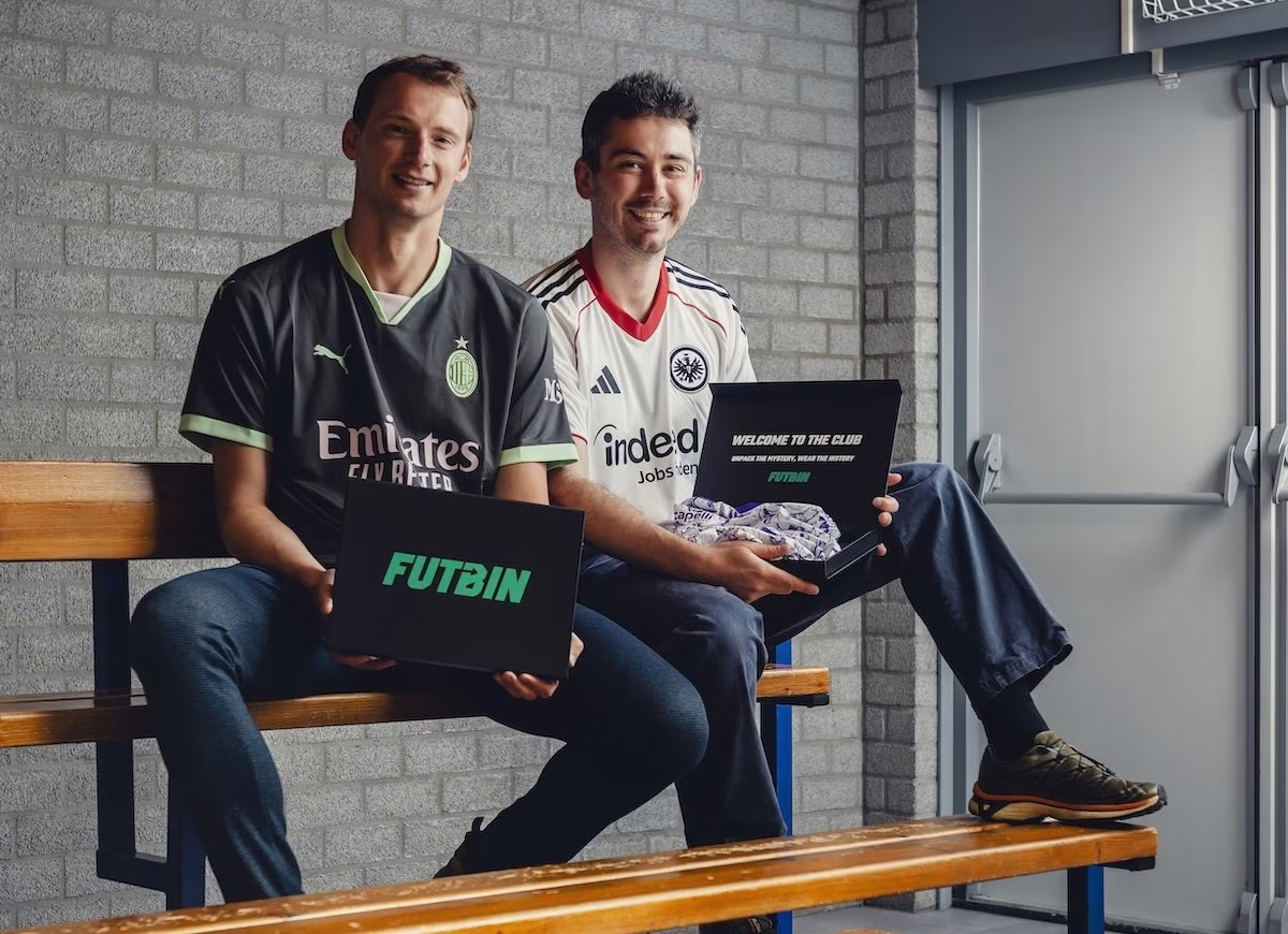 FUTBIN founders on a bench holding a mystery shirt box