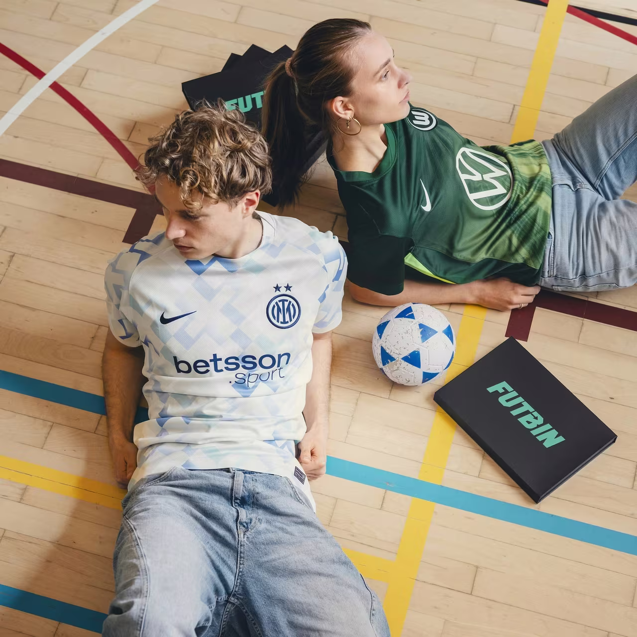 A FUTBIN mystery box with an official football shirt on a mint background